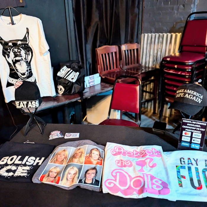 Hustle City Clothing products displayed on tables during a live pop-up retail event.