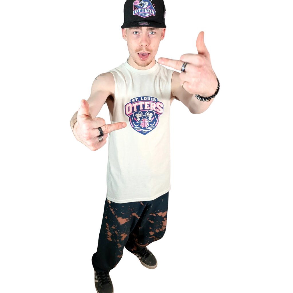 Person wearing a 'St. Louis Otters' tank top and cap, making hand gestures on a white background