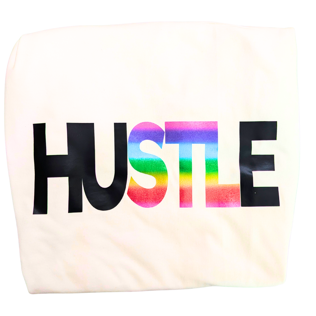 Tote bag with 'HUSTLE' printed in rainbow letters on a white background