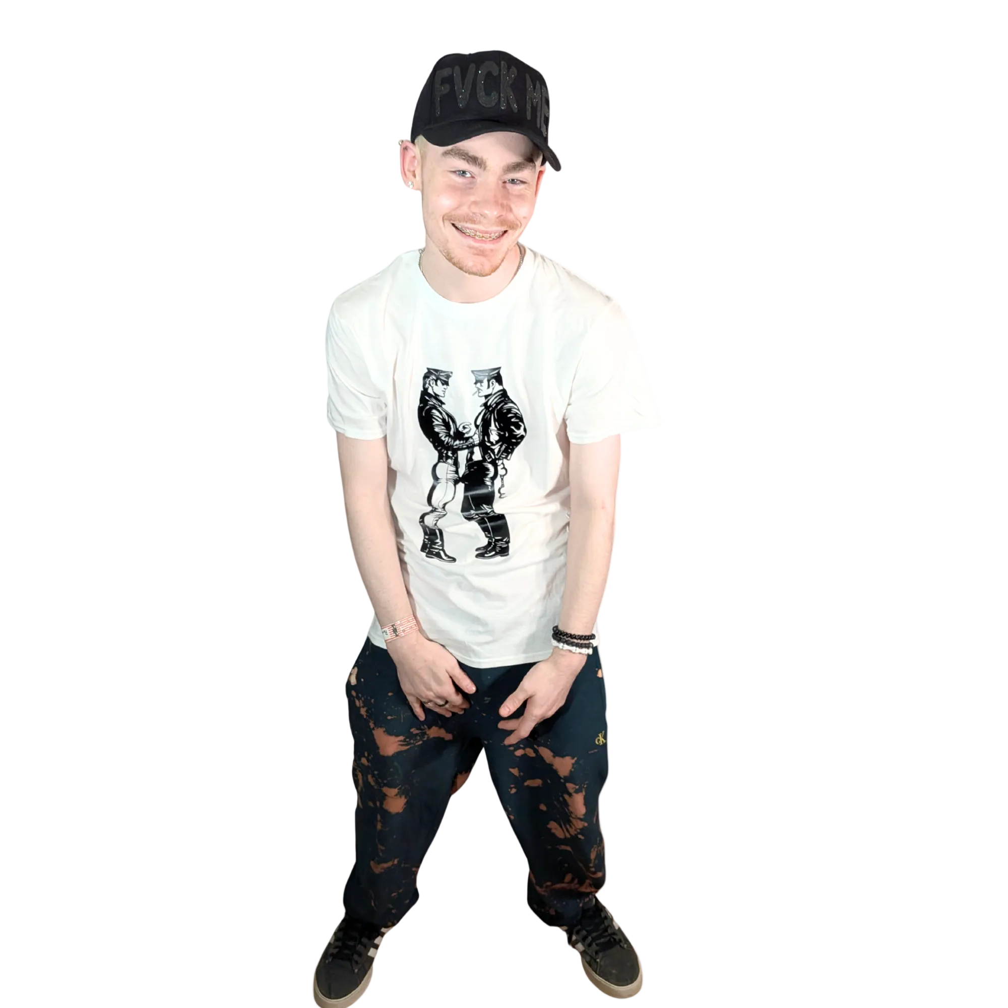 Person wearing a white t-shirt with graphic design, black cap, and dark jeans on a white background