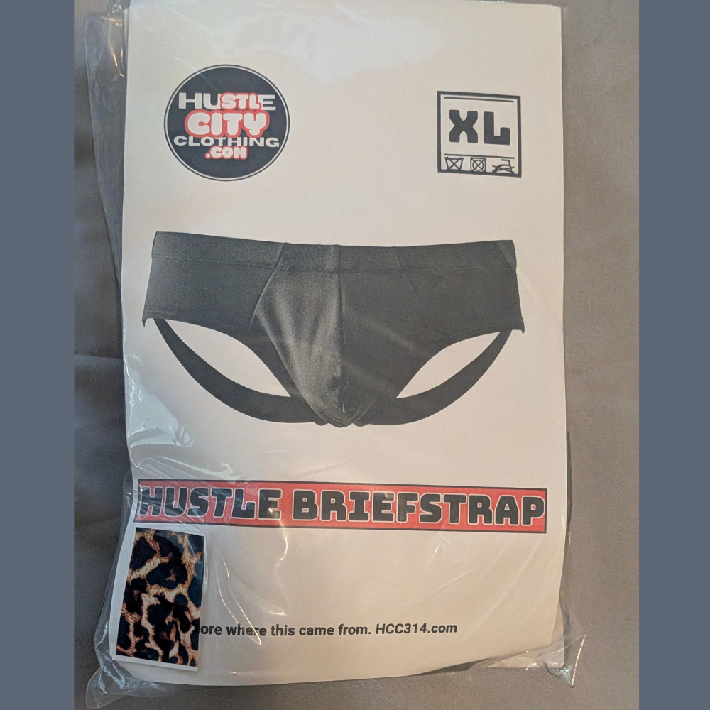 Packaged black Hustle Briefstrap with leopard-print strap detail, size XL