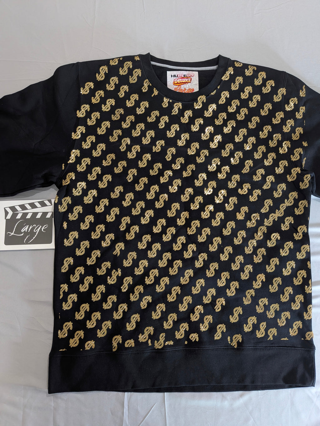 Black sweatshirt with gold pattern on a white background
