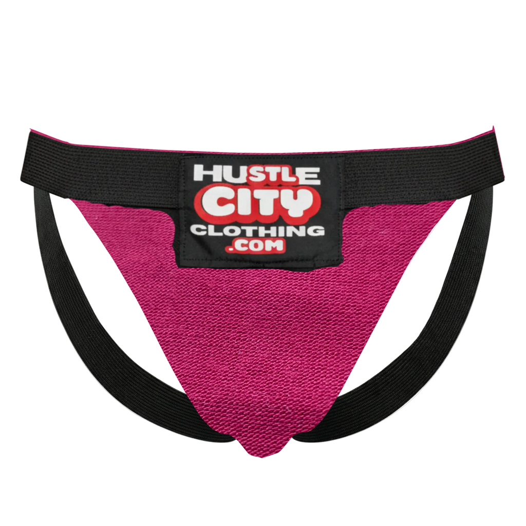 Pink athletic supporter with black waistband featuring 'Hustle City Clothing' label on a white background