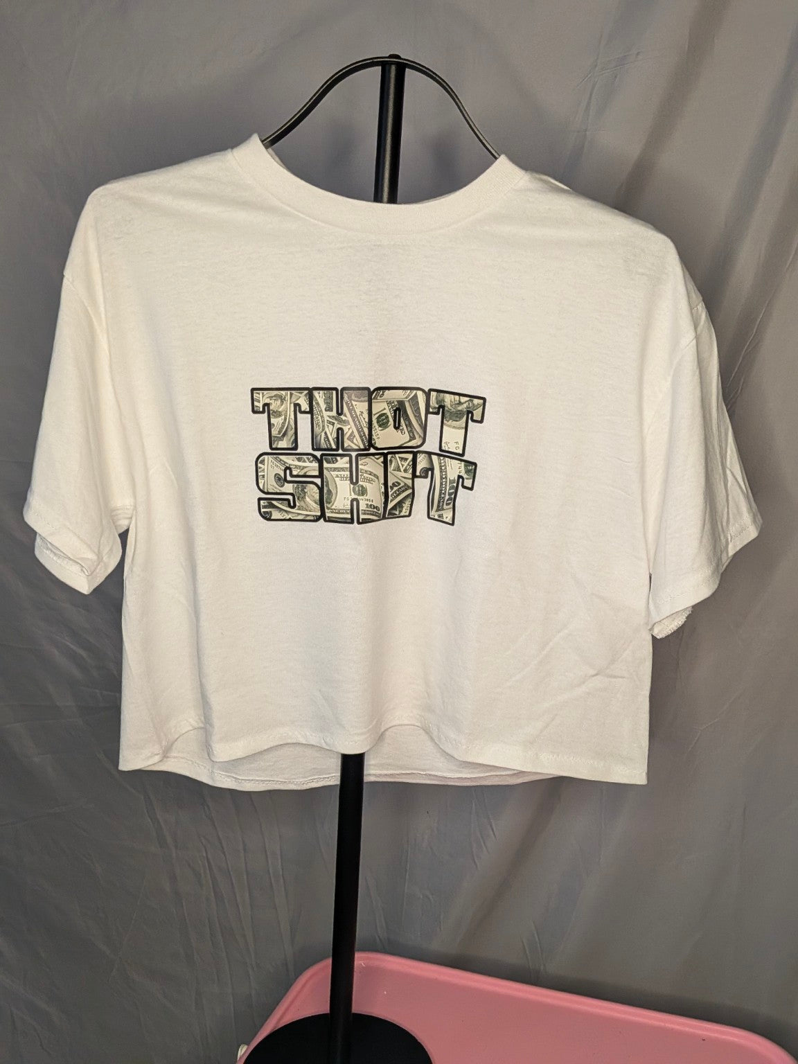 Thot Shit Crop Top in white with money-print graphic on gray backdrop